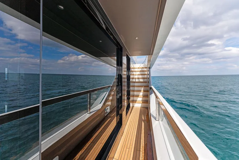 Slide: The Image of Side deck of 2020 Mangusta 109 yacht with ocean view and wooden flooring. - 20