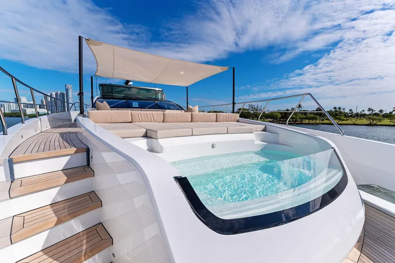 Slide: The Image of Luxurious 2020 Mangusta 109 yacht with sun deck and jacuzzi, under a clear blue sky. - 22