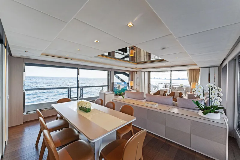 Slide: The Image of Luxurious interior of 2020 Mangusta 109 yacht with ocean view, dining area, and modern decor. - 32
