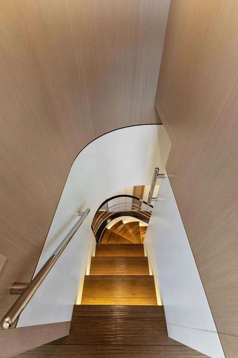Slide: The Image of Modern staircase with wooden steps and sleek design on a 2020 Mangusta 109 yacht. - 34
