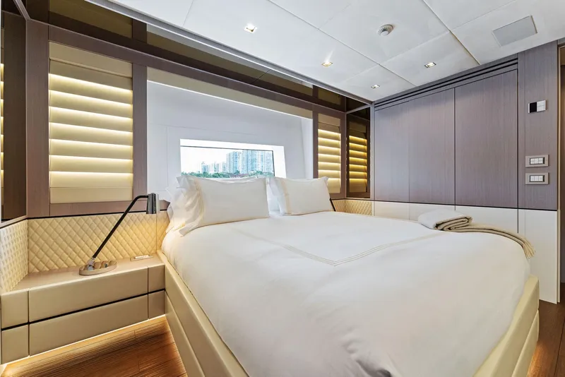 Slide: The Image of Luxurious bedroom interior of 2020 Mangusta 109 yacht with modern design and large window. - 49