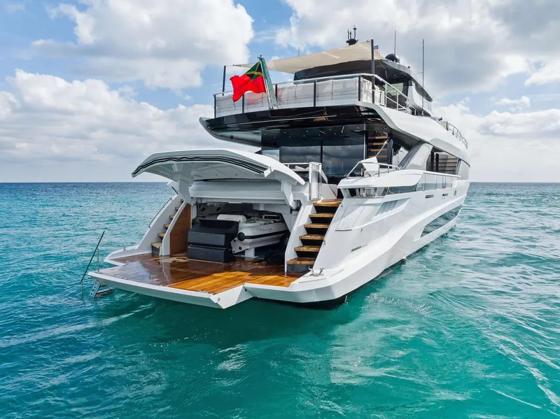 Slide: The Image of Luxury 2020 Mangusta 109 yacht on turquoise waters with open deck and stairs. - 5
