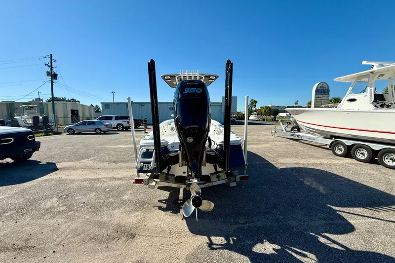 Slide: The Image of 2021 BlackJack 256 Bay boat with powerful outboard motor in a sunny parking lot. - 11