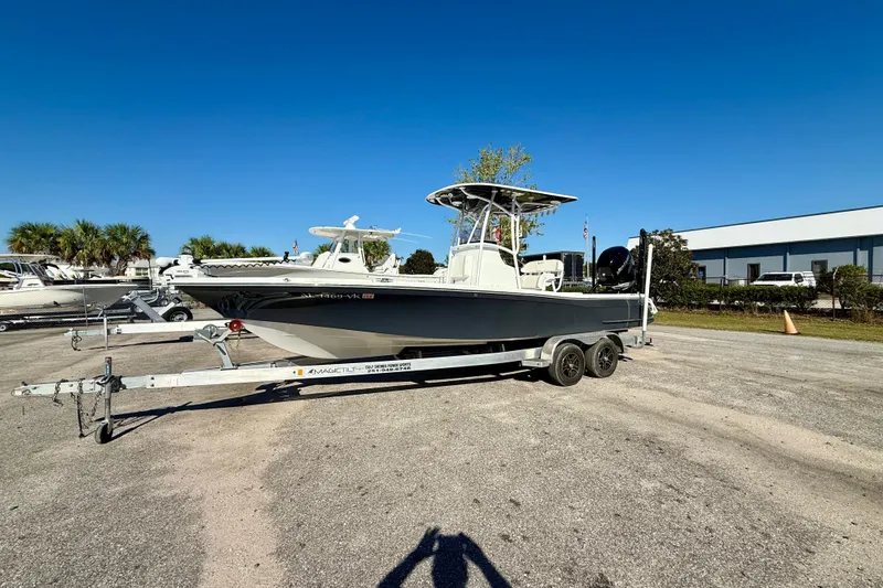 Slide: The Image of 2021 BlackJack 256 Bay boat on trailer in sunny outdoor setting. - 13