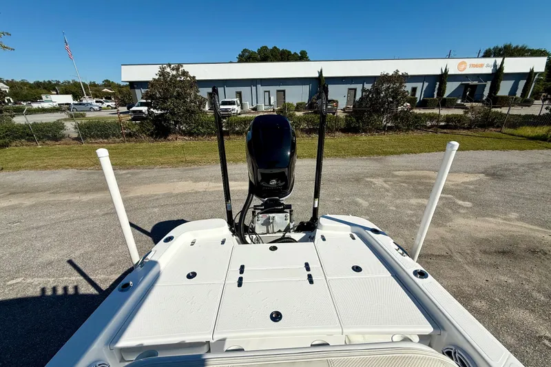 Slide: The Image of 2021 BlackJack 256 Bay boat with motor, parked outdoors near a building. - 14