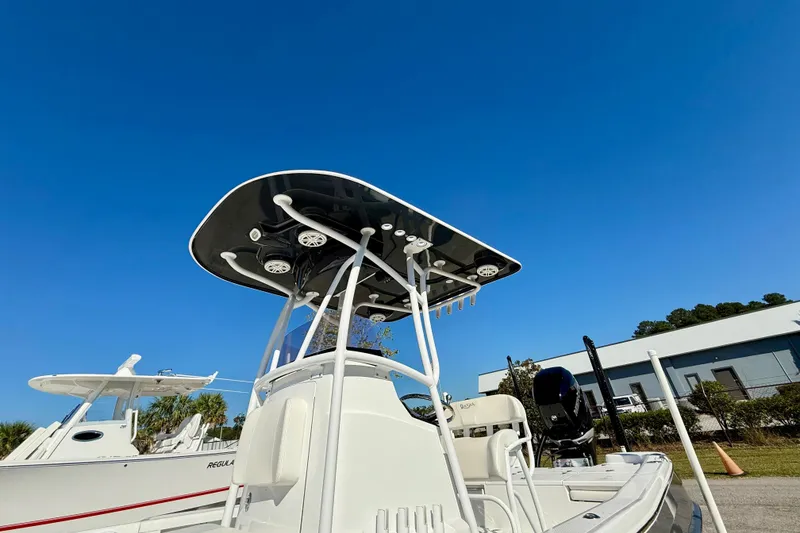 Slide: The Image of 2021 BlackJack 256 Bay boat with T-top under clear blue sky. - 17