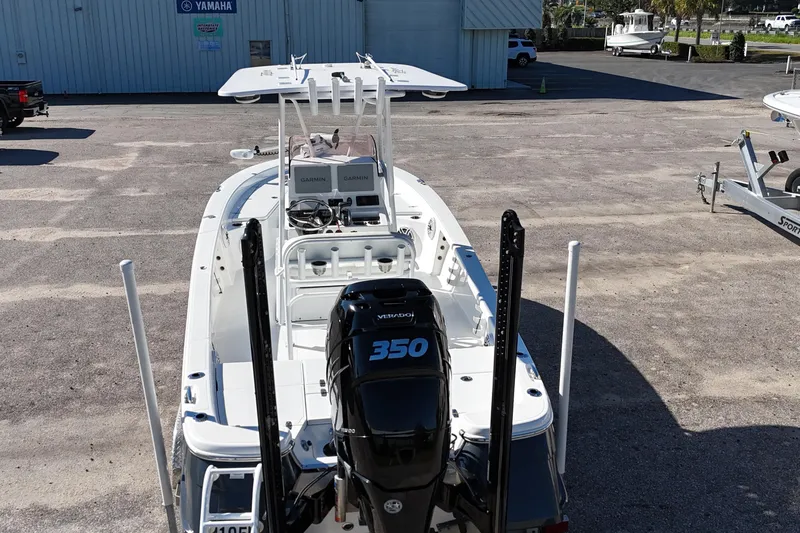 Slide: The Image of 2021 BlackJack 256 Bay boat with 350 horsepower engine, parked near Yamaha building. - 2