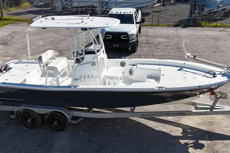 Slide: The Image of 2021 BlackJack 256 Bay boat on trailer, parked near a white truck. - 4