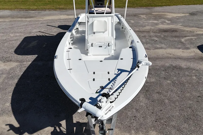 Slide: The Image of 2021 BlackJack 256 Bay boat, white deck, parked on concrete surface. - 6