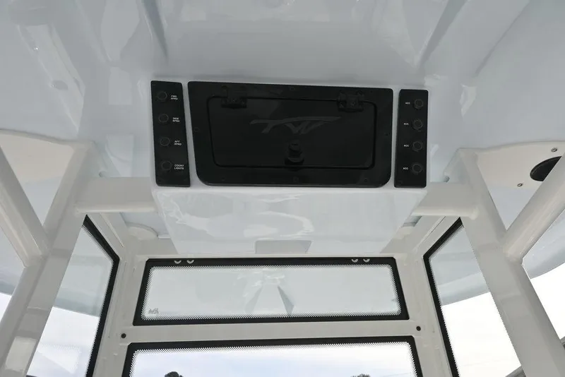 Slide: The Image of 2026 Tidewater 2210 Carolina Bay boat console with control panel and storage compartment. - 12