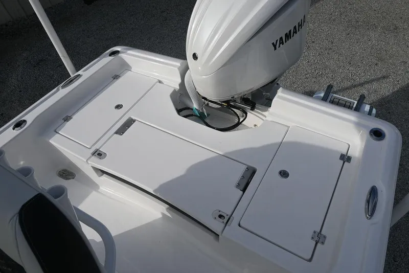 Slide: The Image of 2026 Tidewater 2210 Carolina Bay boat with Yamaha engine, featuring rear deck storage compartments. - 13