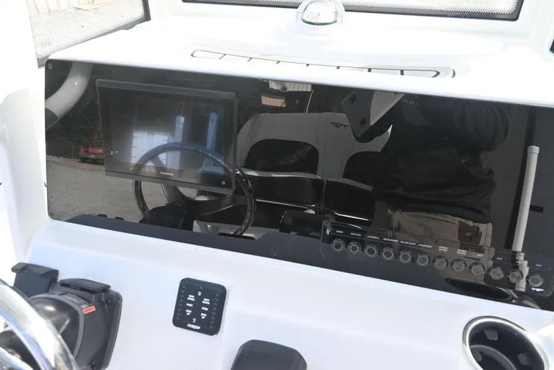 Slide: The Image of 2026 Tidewater 2210 Carolina Bay boat dashboard with steering wheel and electronic display. - 14