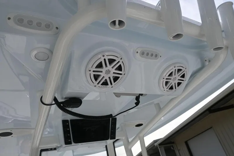 Slide: The Image of 2026 Tidewater 2210 Carolina Bay boat speakers and rod holders on T-top. - 15