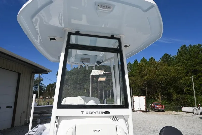 Slide: The Image of 2026 Tidewater 2210 Carolina Bay boat with T-top, parked outdoors. - 21