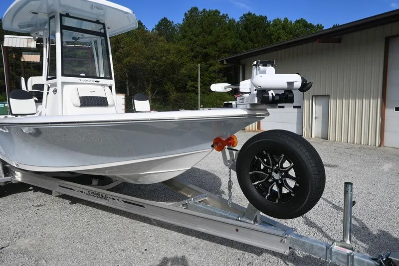 Slide: The Image of 2026 Tidewater 2210 Carolina Bay boat on trailer, parked outdoors near a building. - 4