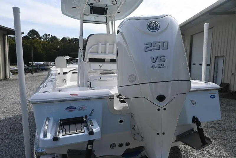 Slide: The Image of 2026 Tidewater 2210 Carolina Bay boat with Yamaha 250 V6 engine, parked outdoors. - 8