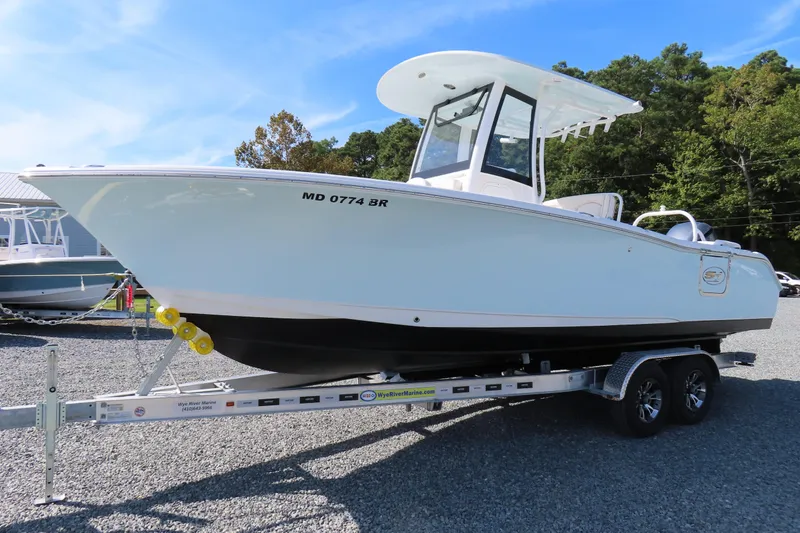 Slide: The Image of 2020 Sea Hunt Ultra 255 SE boat on trailer, parked outdoors. - 1