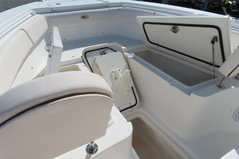Slide: The Image of 2020 Sea Hunt Ultra 255 SE boat interior with open storage compartments. - 10