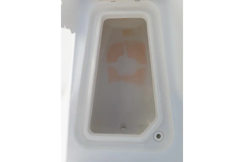 Slide: The Image of Storage compartment of a 2020 Sea Hunt Ultra 255 SE boat, white interior. - 11