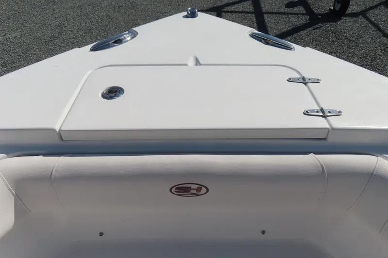 Slide: The Image of 2020 Sea Hunt Ultra 255 SE boat bow with storage compartment and seating. - 14
