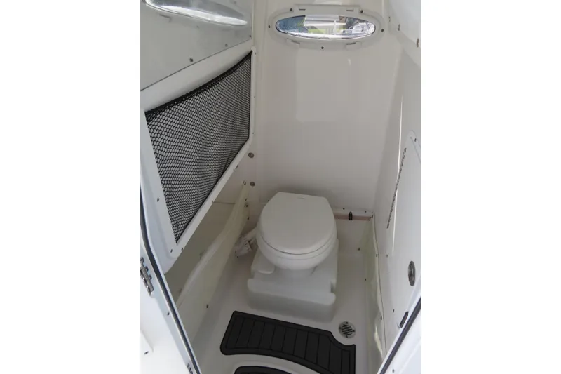 Slide: The Image of 2020 Sea Hunt Ultra 255 SE boat interior with compact marine toilet. - 19