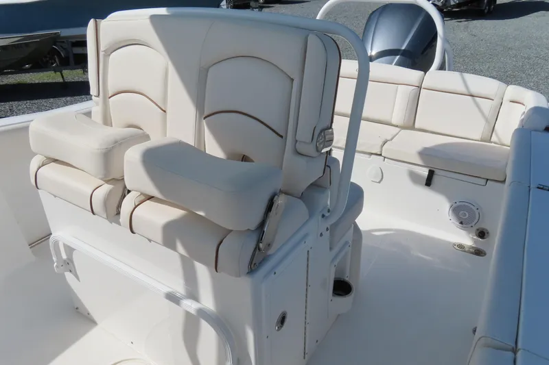 Slide: The Image of 2020 Sea Hunt Ultra 255 SE boat interior with cushioned seating and console. - 20