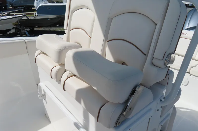 Slide: The Image of 2020 Sea Hunt Ultra 255 SE boat seats with white upholstery and armrests. - 21