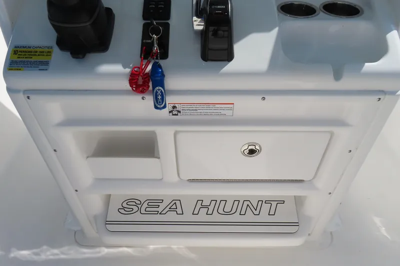 Slide: The Image of Control panel of 2020 Sea Hunt Ultra 255 SE boat with storage and cup holders. - 26
