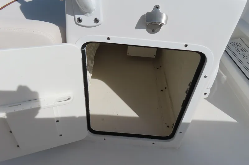 Slide: The Image of Open storage compartment on a 2020 Sea Hunt Ultra 255 SE boat. - 29