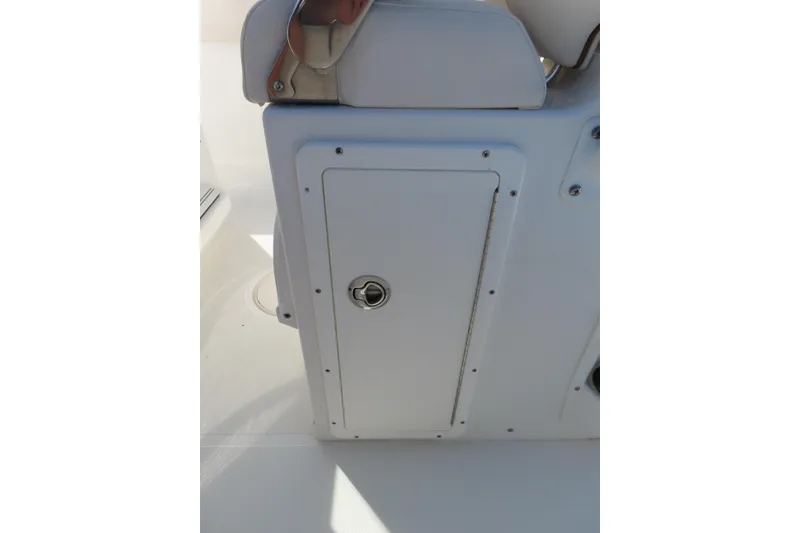 Slide: The Image of 2020 Sea Hunt Ultra 255 SE boat storage compartment with secure latch. - 30
