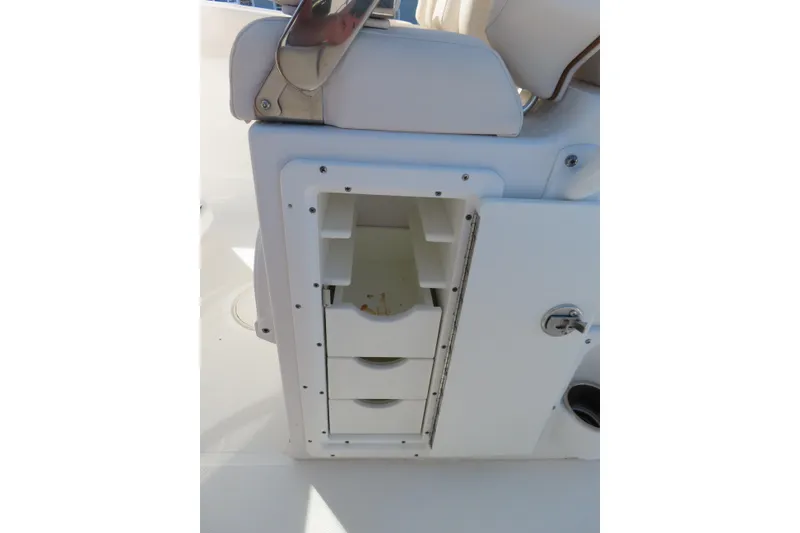 Slide: The Image of 2020 Sea Hunt Ultra 255 SE boat storage compartment with drawers and latch. - 31
