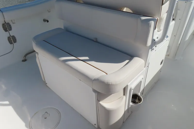 Slide: The Image of 2020 Sea Hunt Ultra 255 SE boat interior seating with white upholstery. - 33