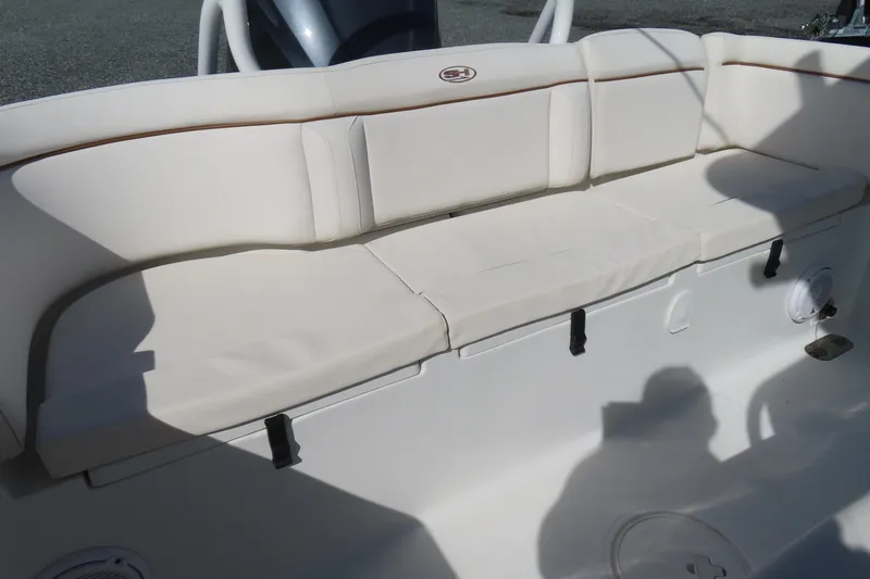Slide: The Image of 2020 Sea Hunt Ultra 255 SE boat with white cushioned seating area. - 35