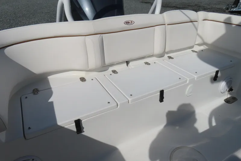 Slide: The Image of 2020 Sea Hunt Ultra 255 SE boat seating area with storage compartments. - 36