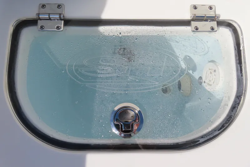 Slide: The Image of Livewell lid on 2020 Sea Hunt Ultra 255 SE boat, with water droplets. - 38