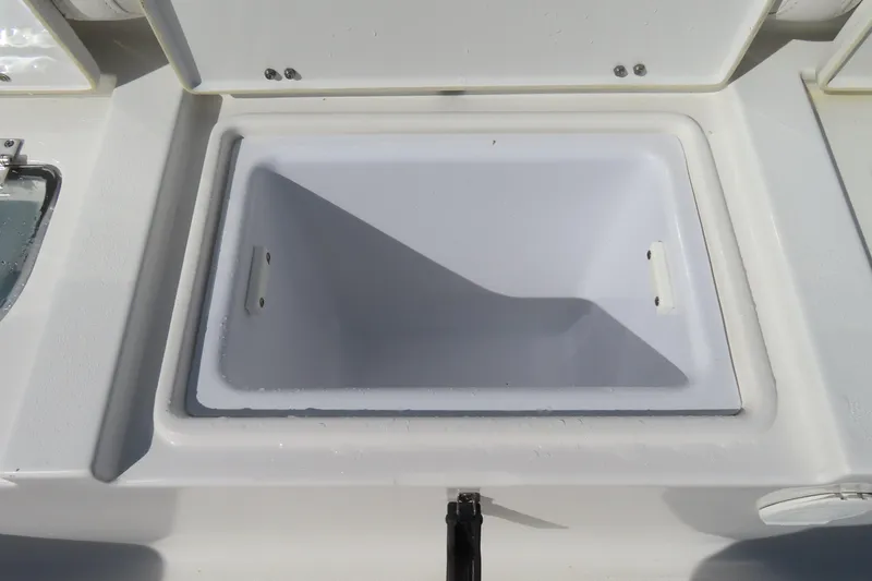 Slide: The Image of Open storage compartment on a 2020 Sea Hunt Ultra 255 SE boat. - 40