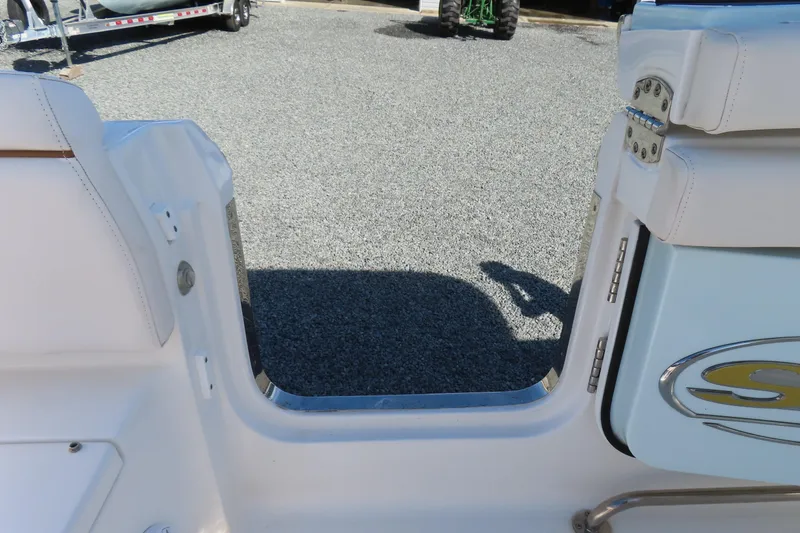 Slide: The Image of 2020 Sea Hunt Ultra 255 SE boat entryway with seating and logo detail. - 43