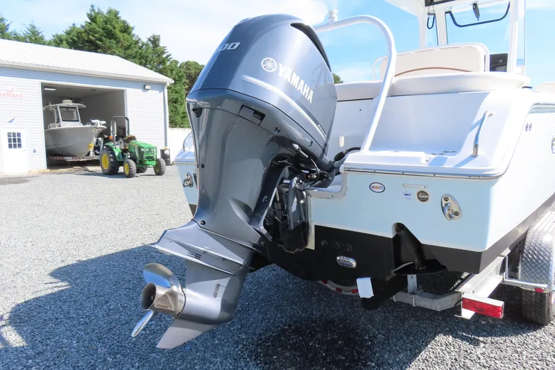 Slide: The Image of 2020 Sea Hunt Ultra 255 SE boat with Yamaha outboard motor in a marina setting. - 5