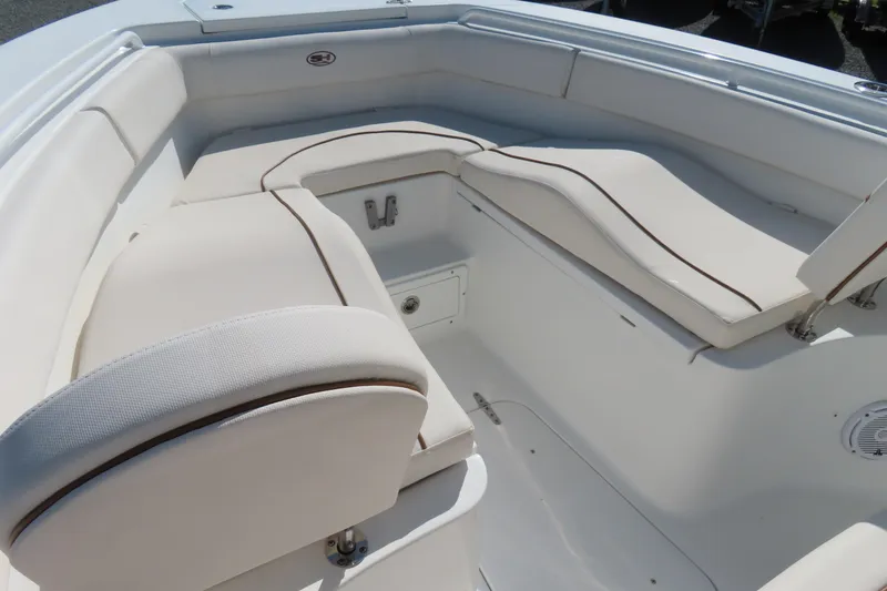 Slide: The Image of 2020 Sea Hunt Ultra 255 SE boat interior with white cushioned seating. - 8