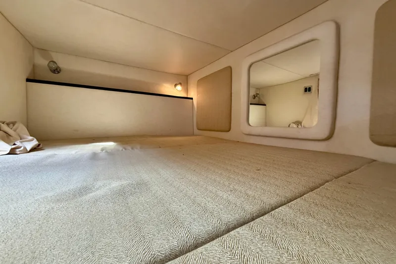 Slide: The Image of Interior cabin of 2006 Sea Ray 290 Sundancer, featuring cozy sleeping area. - 13