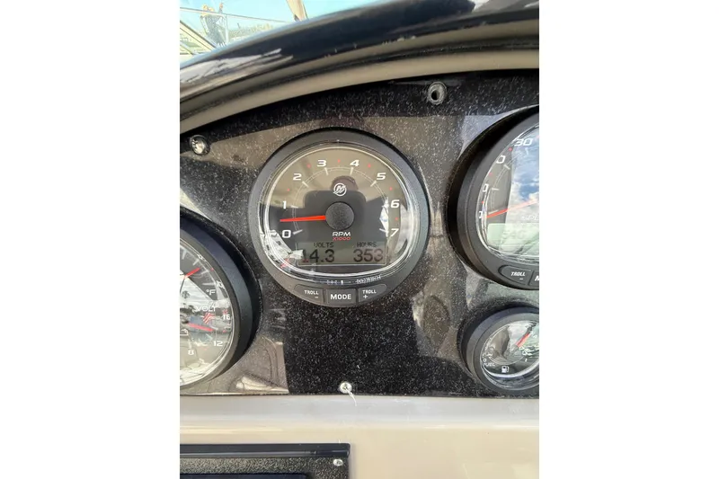 Slide: The Image of Dashboard of 2006 Sea Ray 290 Sundancer showing RPM and voltage gauges. - 23