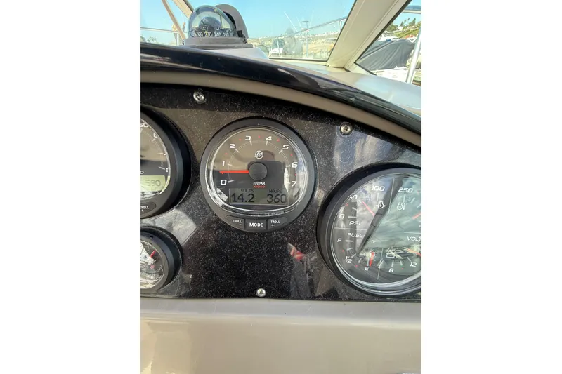 Slide: The Image of Dashboard of 2006 Sea Ray 290 Sundancer boat showing RPM and fuel gauges. - 24