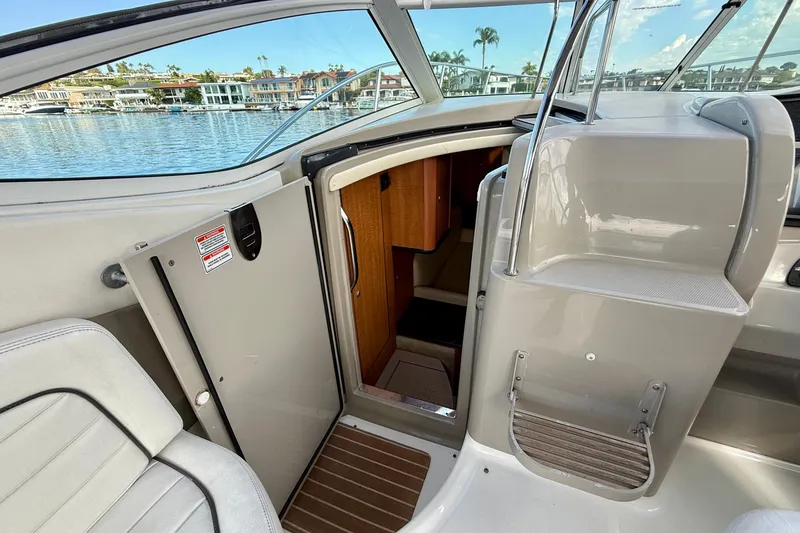 Slide: The Image of 2006 Sea Ray 290 Sundancer cabin entrance with waterfront view. - 28