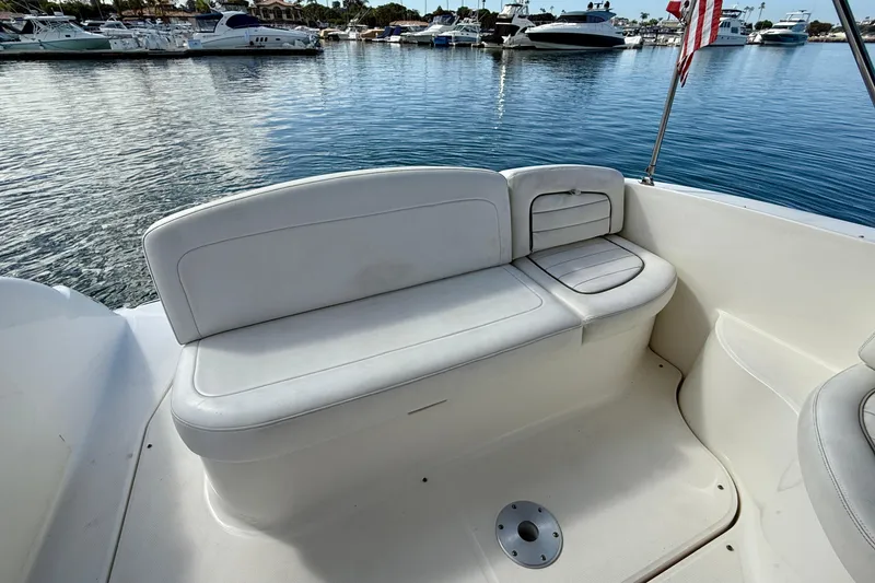 Slide: The Image of 2006 Sea Ray 290 Sundancer boat interior with white seating, docked in marina. - 37