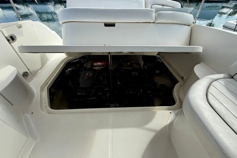 Slide: The Image of 2006 Sea Ray 290 Sundancer engine compartment with open hatch, revealing interior components. - 39