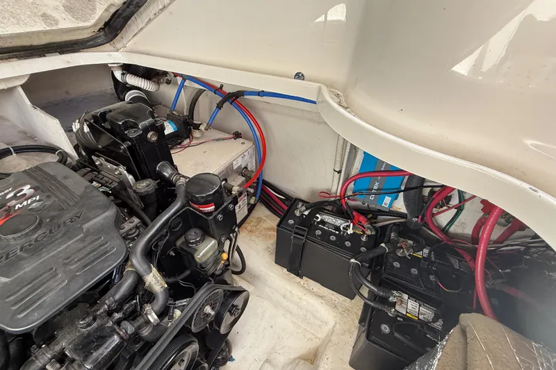 Slide: The Image of Engine compartment of a 2006 Sea Ray 290 Sundancer with visible batteries and wiring. - 41