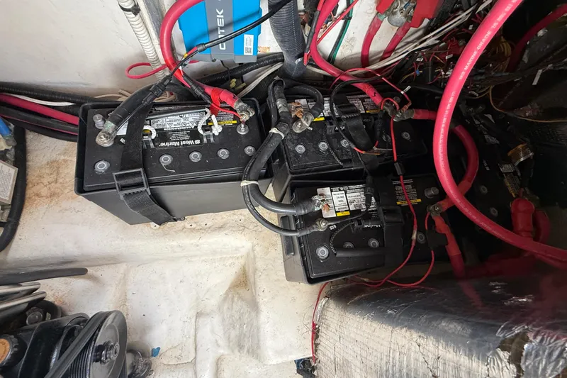 Slide: The Image of Battery compartment of a 2006 Sea Ray 290 Sundancer with multiple batteries and wiring. - 42