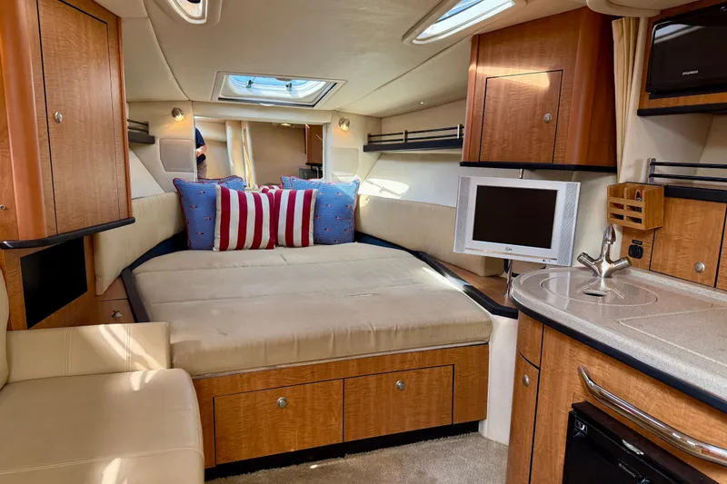 Slide: The Image of Luxurious 2006 Sea Ray 290 Sundancer cabin interior with cozy bed and modern amenities. - 8