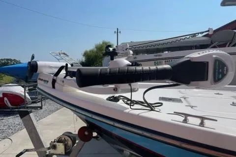 Slide: The Image of 2016 Blazer Bay 1960 boat with trolling motor, docked outdoors on a sunny day. - 6