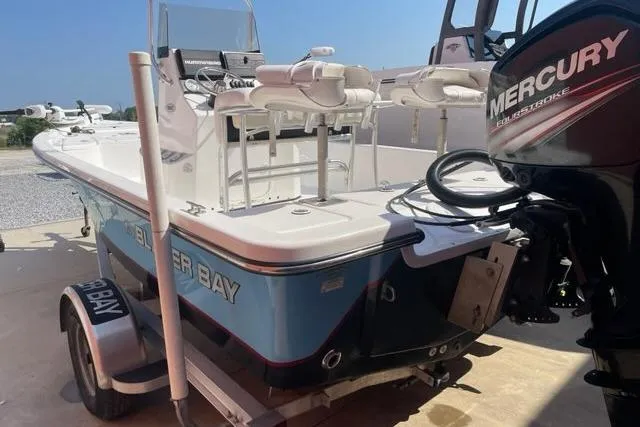 Slide: The Image of 2016 Blazer Bay 1960 boat with Mercury engine on trailer, outdoor setting. - 7